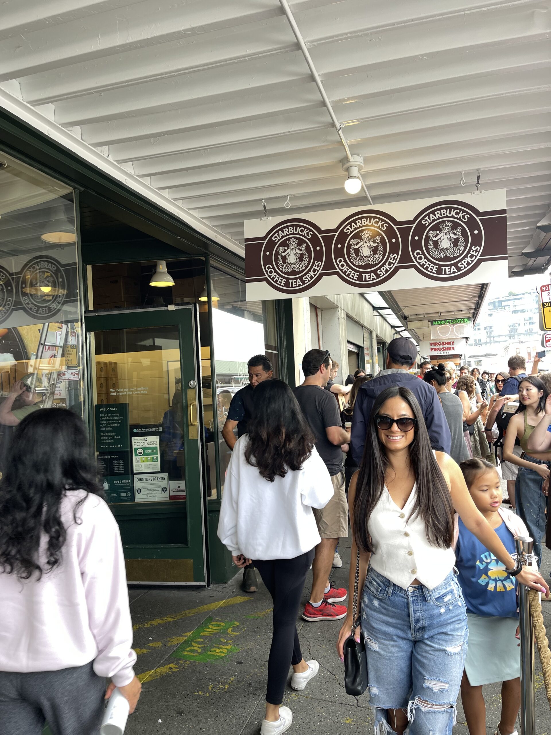 girl standing in front of the world's first starbucks 